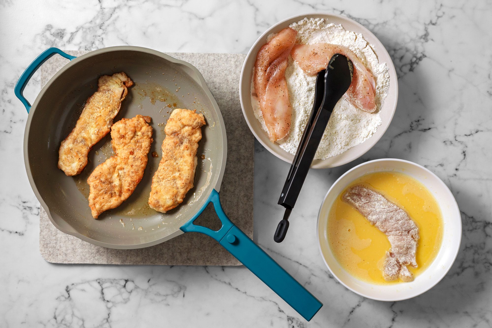 Dip chicken in flour to coat both sides, shake off excess. Dip in egg and place immediately into hot pan, cook until browned