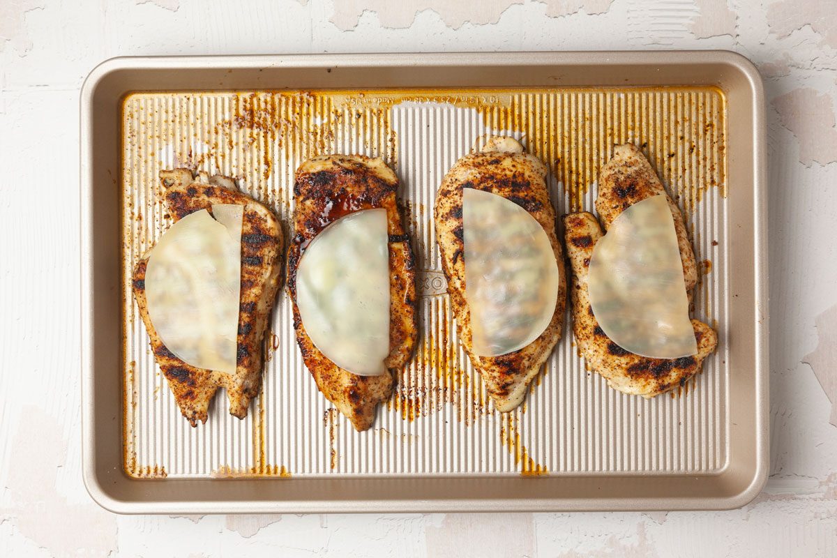 Step 3 of Taste of Home Chicken with Spinach and Mushrooms is to grill the chicken and then add the cheese and return to melt