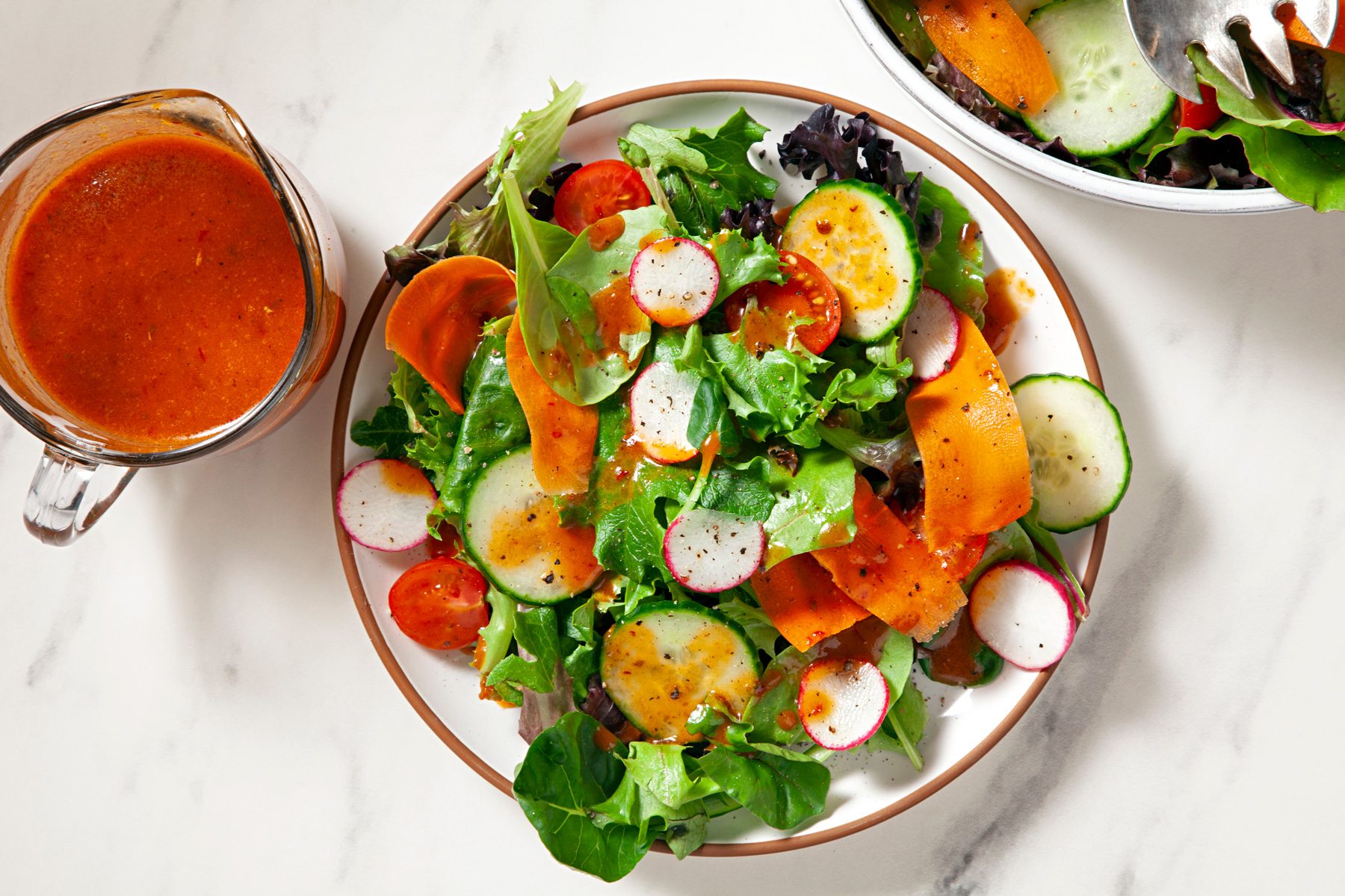 A plate of fresh salad served with Chipotle honey vinaigrette dressing.