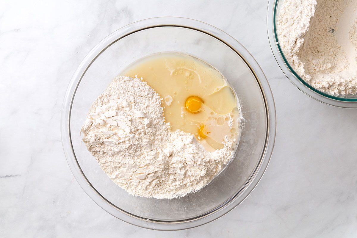 Sugar, salt, eggs, canola oil in mixing bowl with dissolved yeast and 3 cups of flour for step one of Country White Bread for Taste of Home