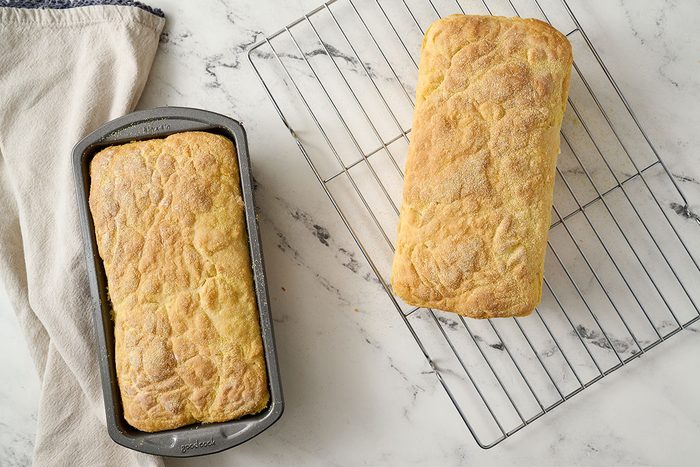 Overhead view of the English muffin bread loaves baking until golden brown and cooling on a wire rack for the Taste of Home English Muffin Bread recipe.