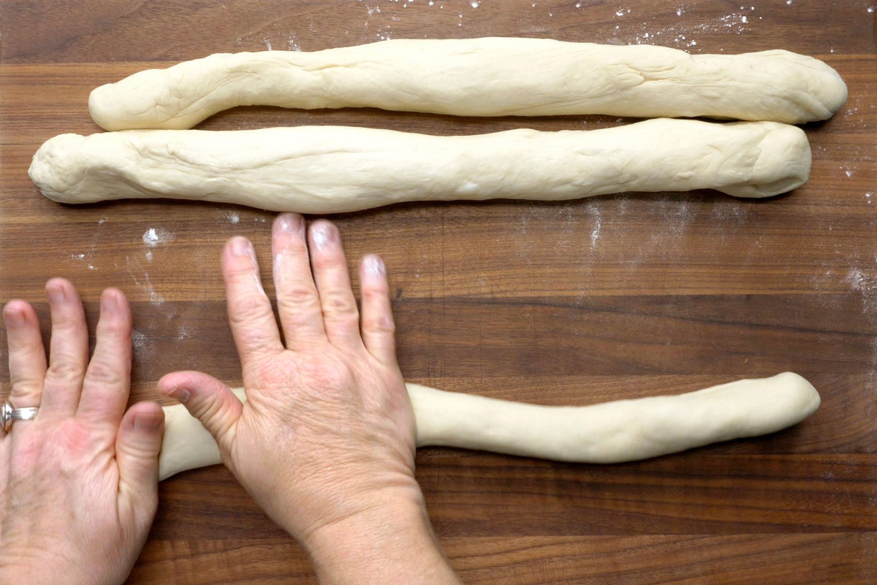 Dough being shaped into ropes.