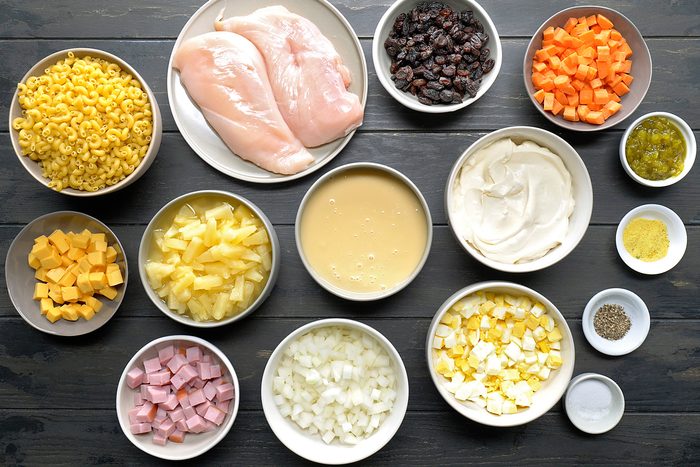 overhead shot of Filipino Macaroni Salad ingredients placed over dark background;