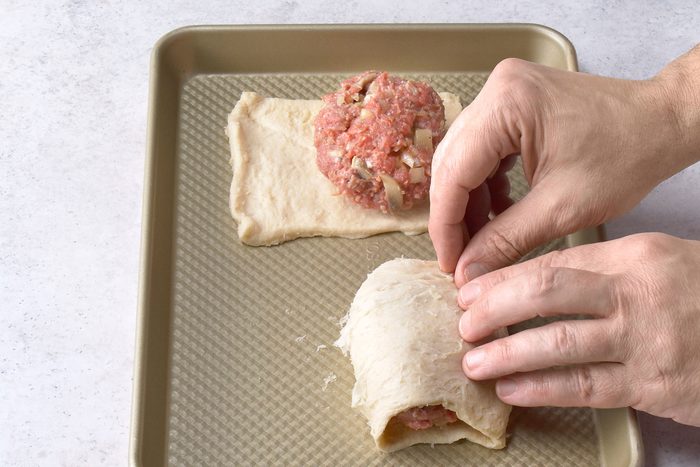 Bringing rectangular dough sheet edges together and pinching them to seal