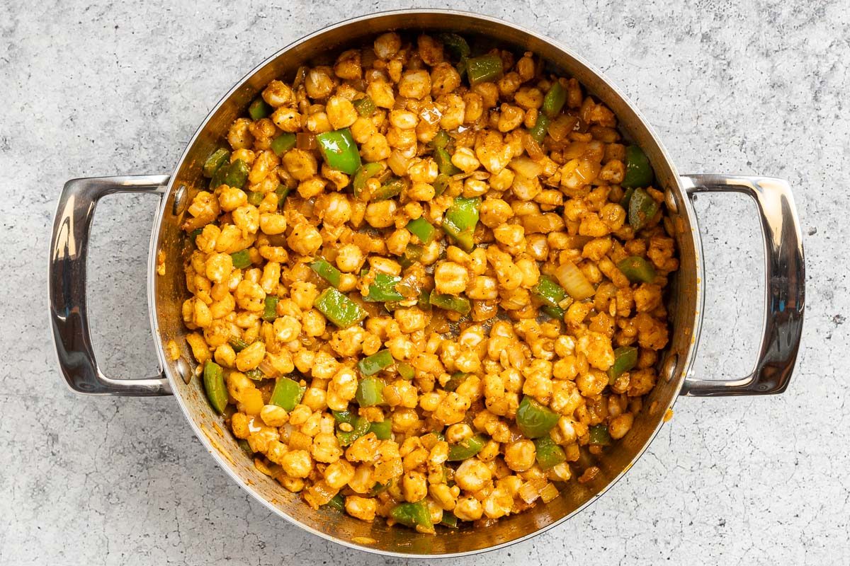 Taste of Home Hominy Recipe photo of the hominy and seasonings added to the pan.