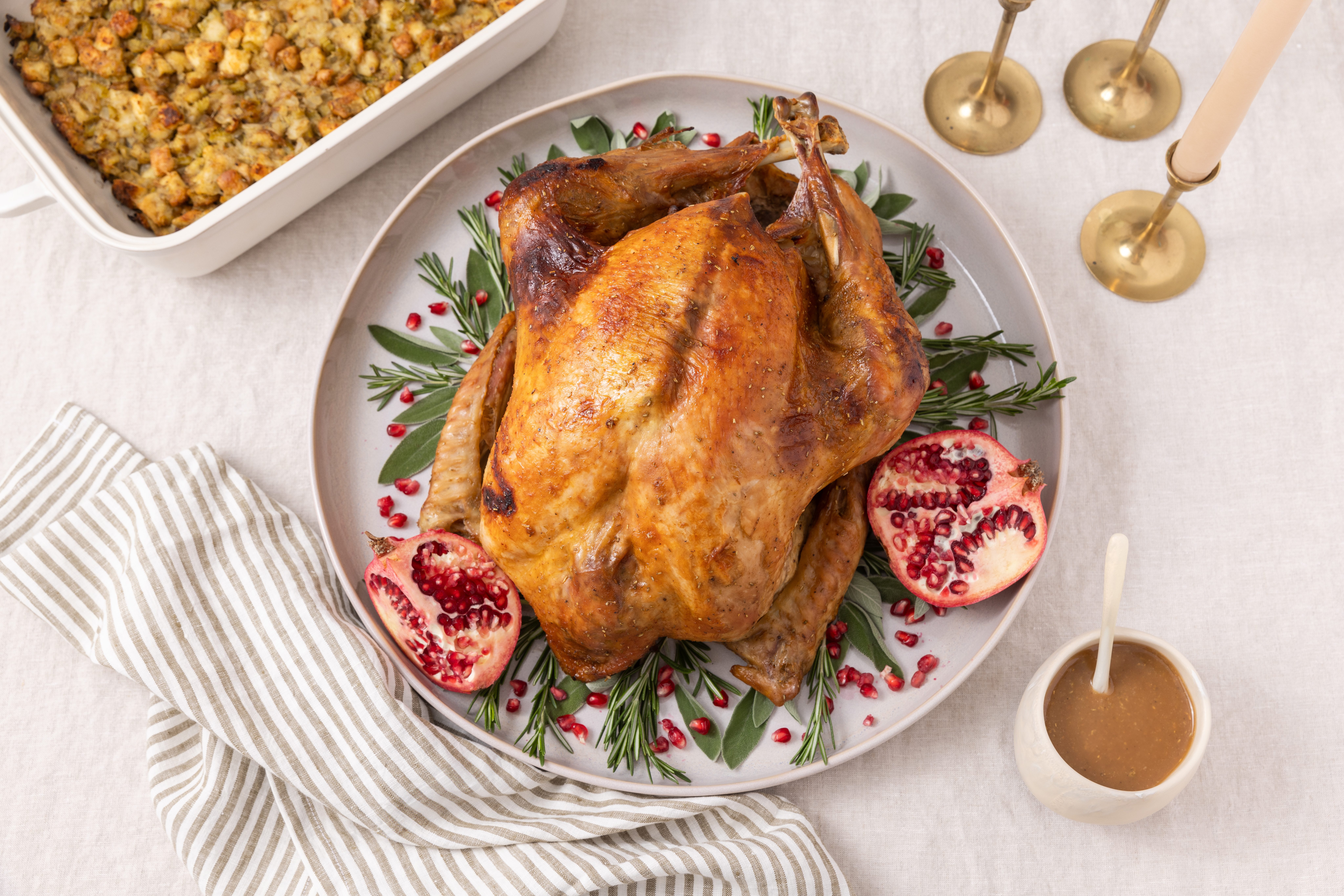Honey glazed turkey ready and garnished on serving dish with stuffing on the side.
