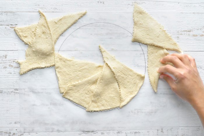 On a work surface, unroll and separate remaining crescent dough into triangles.