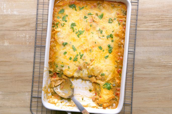 Baked King Ranch Casserole in a baking dish with a spoon