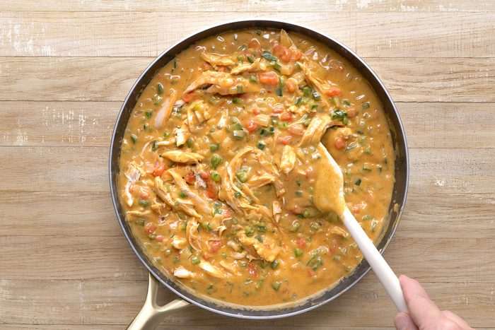 Chicken stirred in chicken broth and vegetables