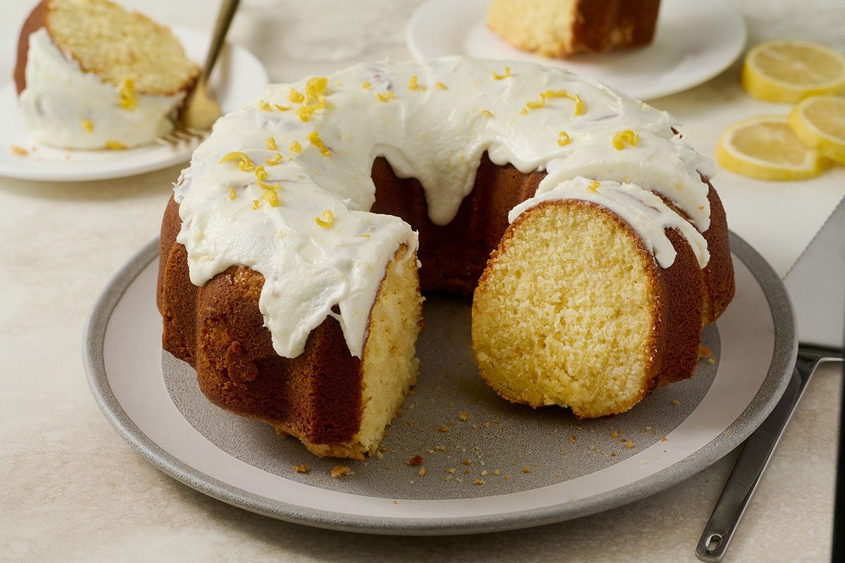 Close-up horizontal shot of the Taste of Home Lemon Pound Cake, highlighting the moist crumb texture and glossy lemon frosting.