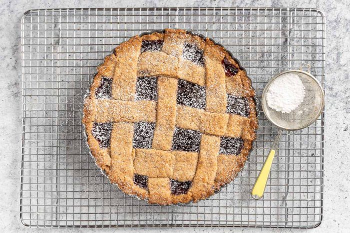 Taste of Home Linzer Torte photo of the baked torte with confectioners sugar.