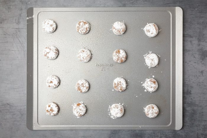 Step 3 of Taste of Home Molasses Crackle Cookies is to roll in powdered sugar, flattena and bake