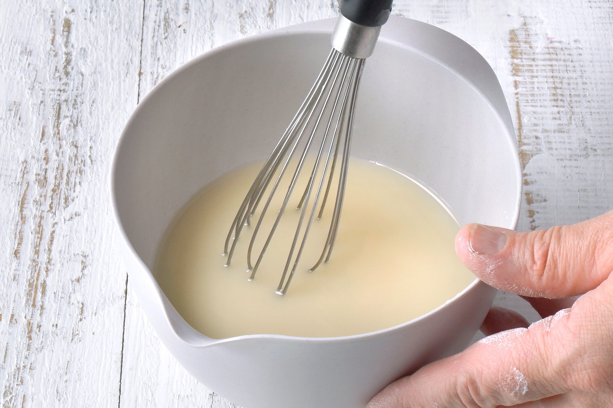 Cornstarch and broth mixture whisked together in a bowl