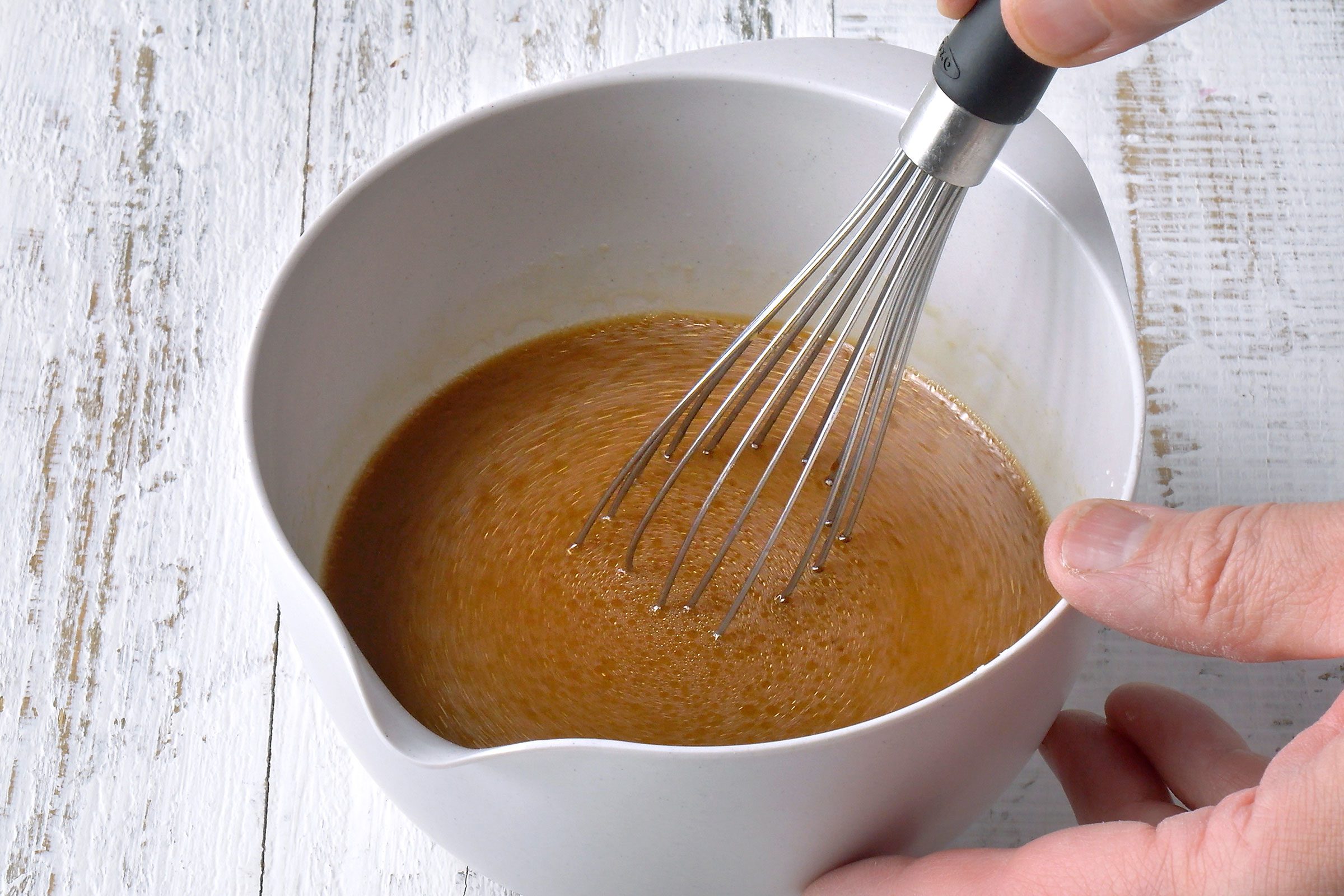Sauces and broth whisked together in a bowl