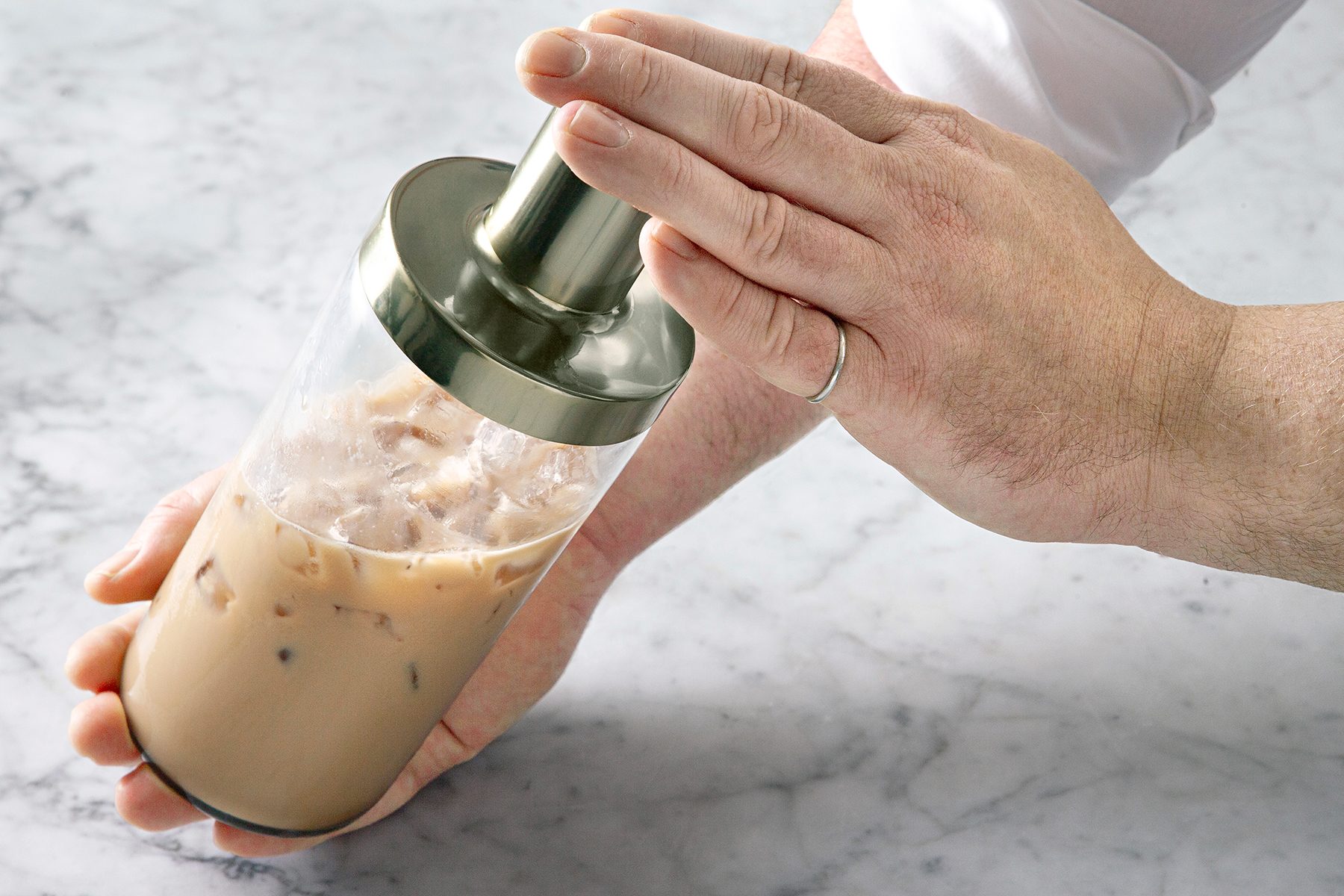 A person holding a shaker.