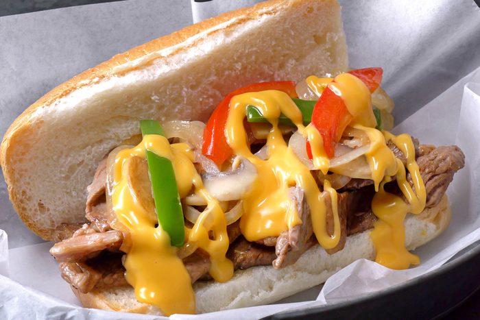 Philly Cheesesteak served on a plate with butter paper on it