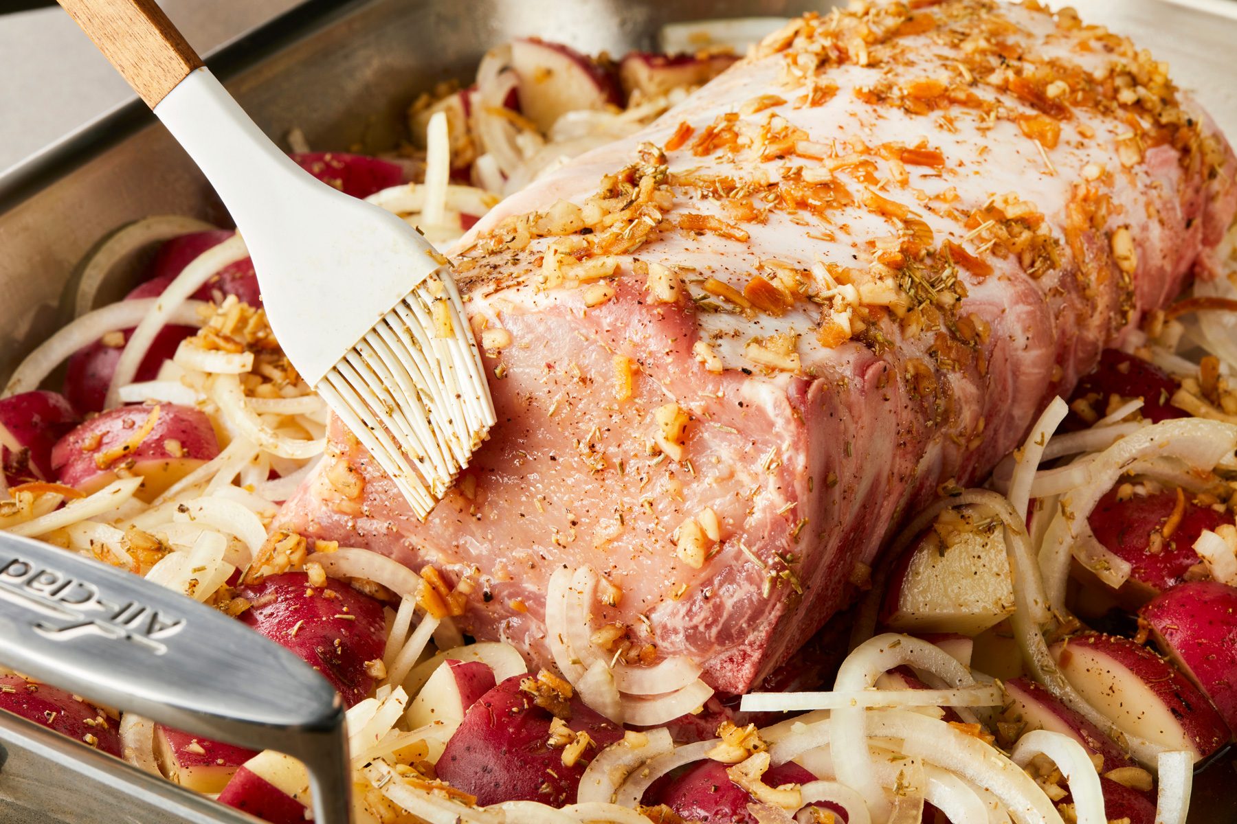 close up shot of Brushing vegetables and roast with seasoning mixture