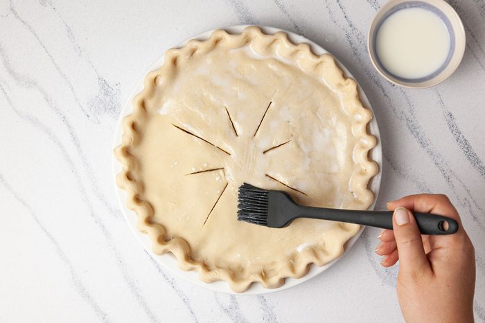 Step 4 of Taste of Home Savory Meat Pie is to crimp the crust and brushhte pie with milk