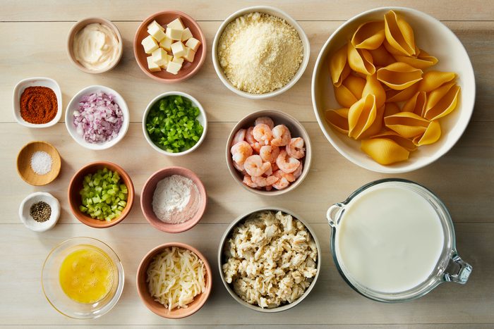 Jumbo pasta shells, Crab, Shrimp, Seafood seasoning, Eggs and mayonnaise, Parmesan cheese sauce in small bowls