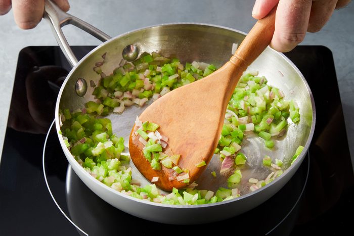 Cooking green pepper, onion and butter in a small skillet