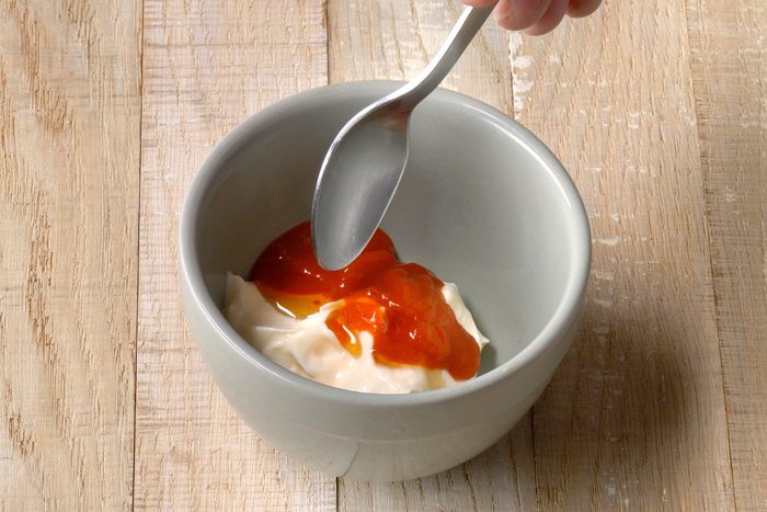 mayonnaise, Sriracha and sesame oil combined in a small bowl
