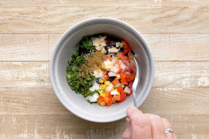 avocado, tomato, olives, corn, red pepper, lime juice, cilantro, salt, onion, garlic and cumin combined in a small bowl