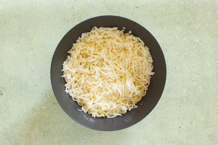 Stuffed Hash browns ingredients, grated cheese and onions mixed
