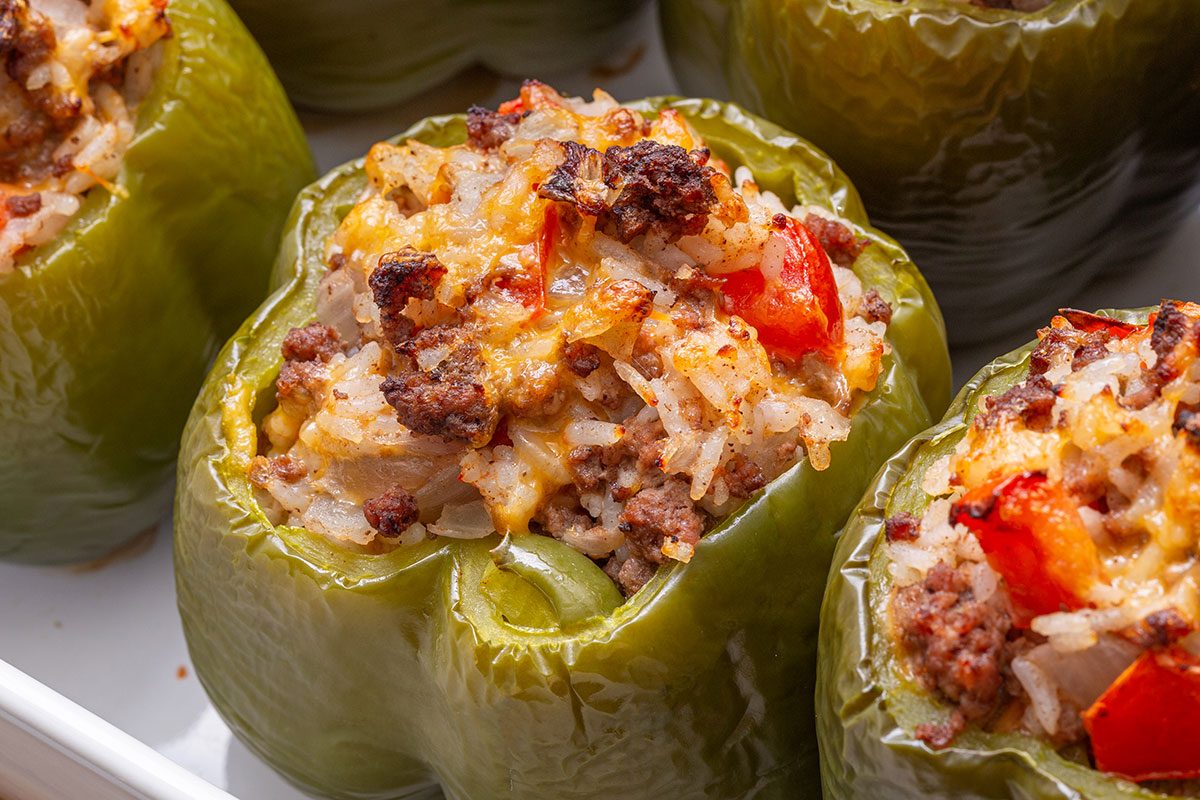 Close up shot of Stuffed Peppers with Cheese in a baking dish for Taste of Home