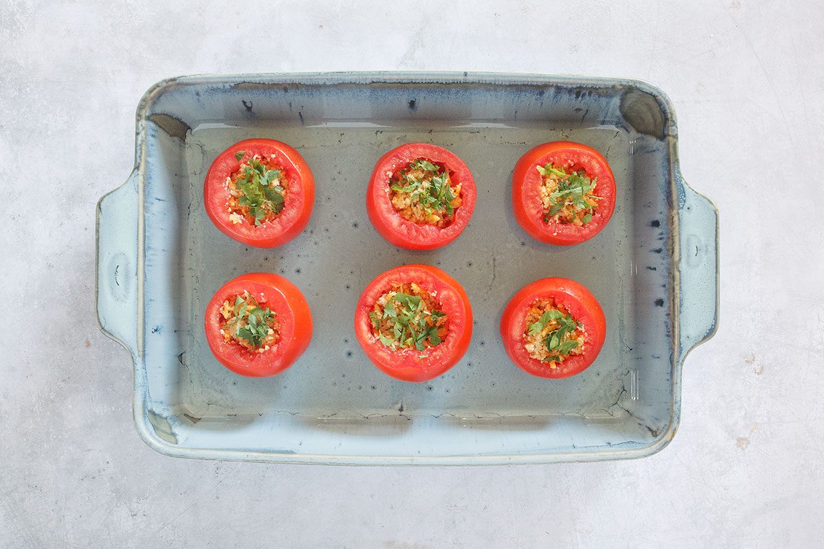 Stuffing added to sliced tomatoes