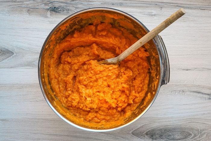Combining the mashed sweet potatoes with the pineapple, eggs, vanilla, nutmeg and salt.