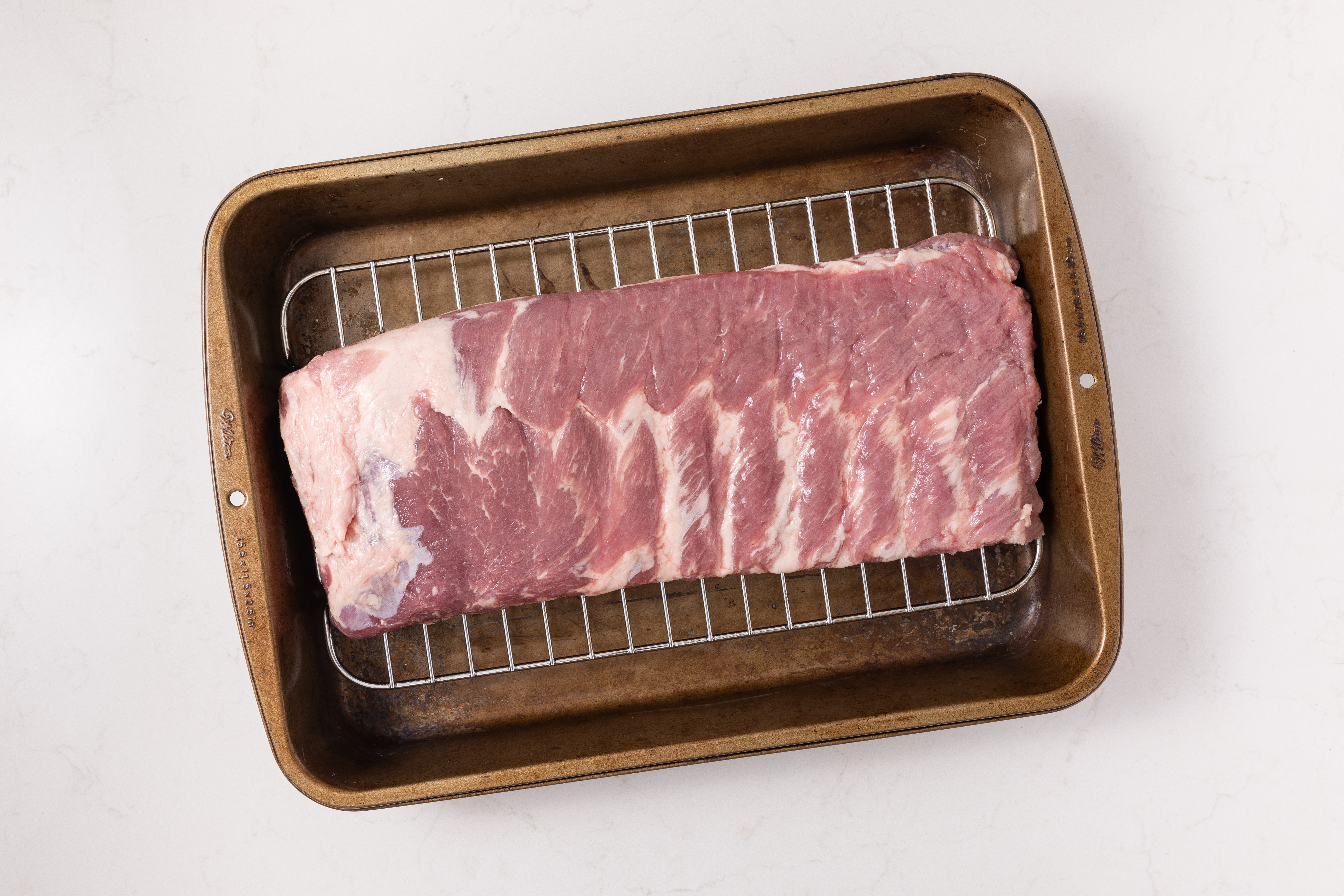 Spareribs on baking tray.