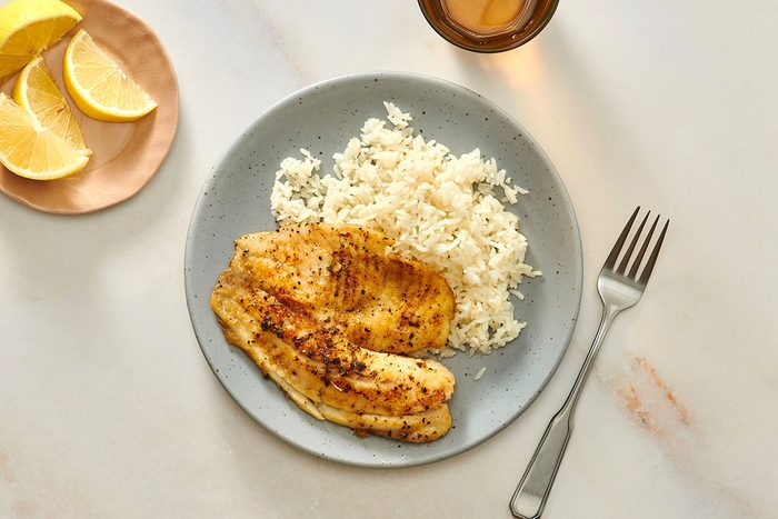 Tilapia fillet served with cooked rice