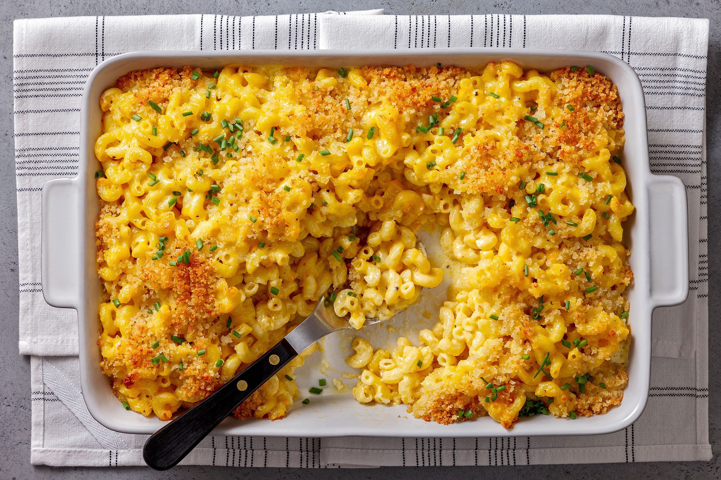 Truffle Mac And Cheese topped with chives in a dish
