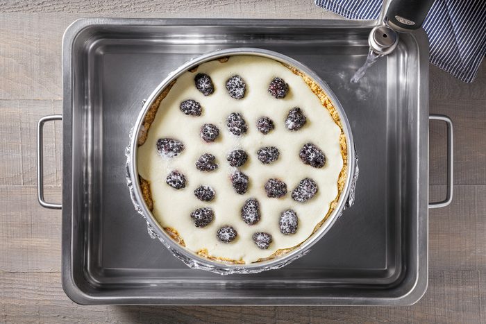 Springform pan placed in a large pan with water filled in it