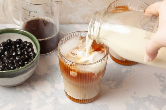 sweetener being added to ice and tea