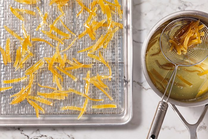Using a slotted spoon, transfer strips to wire racks placed over a baking pan.