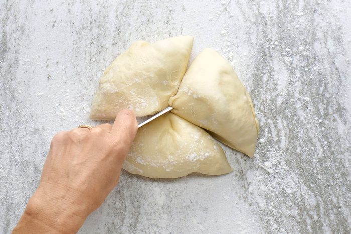 Punch down the dough and divide it into three equal pieces