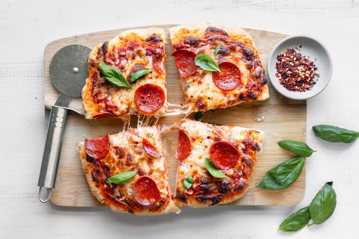 pizza sliced into four parts