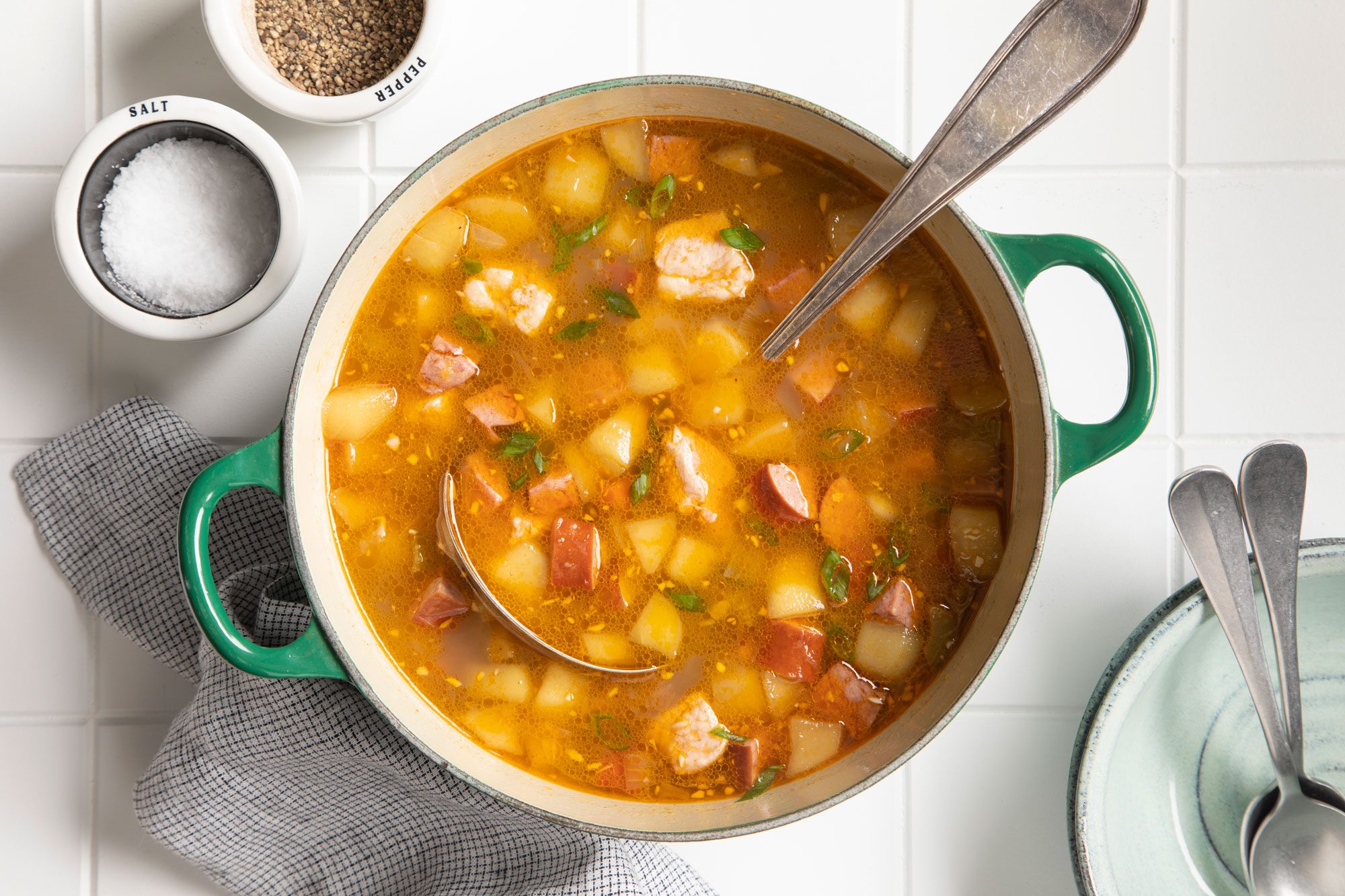 Pork Chop Soup served in a bowl with sal and black pepper on the side