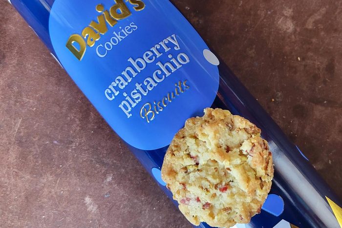 A cylindrical blue package of David's cranberry pistachio cookies