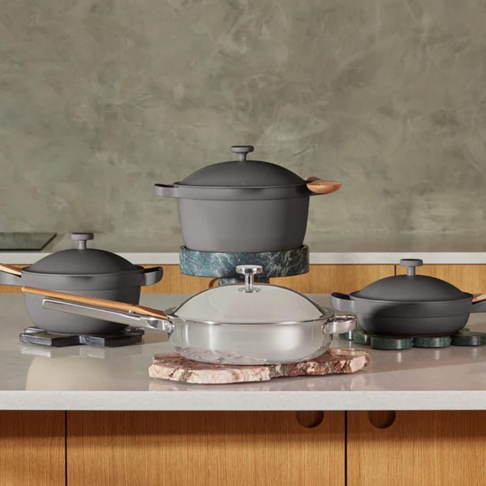 Four pots on a wooden and gray stone background