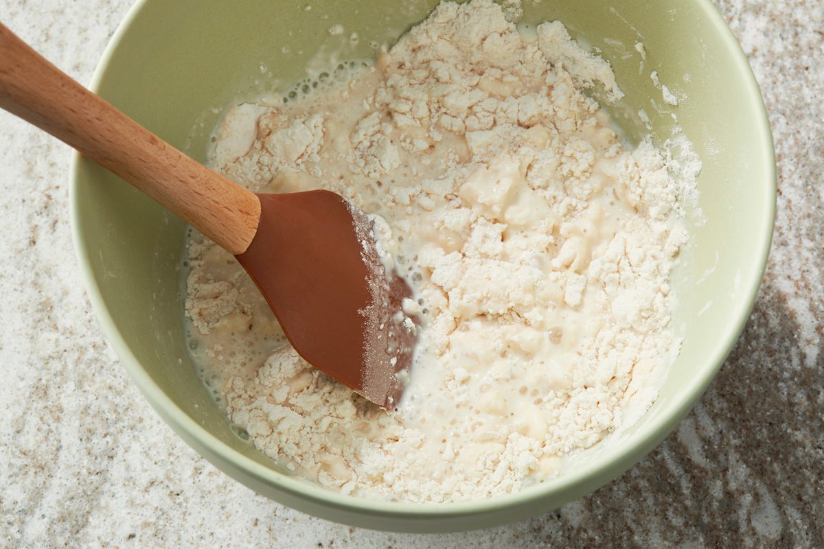 Add the milk and mix just until moistened a few lumps will remain set aside