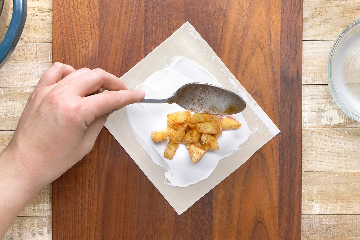 apple mixture being added below the centre of egg roll wrapper