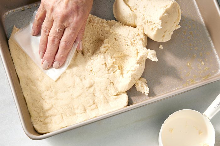 dough pressed into bottom of baking pan