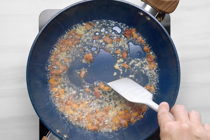 In a large skillet, heat oil over medium heat. Add pancetta, cook and stir until crispy