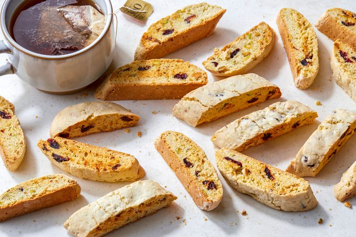 Cranberry and Pistachio Biscotti; serve on cutting board; a cup of tea