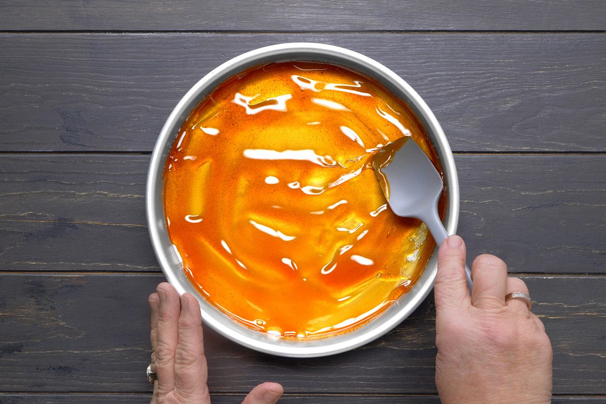 caramel being poured into a cake pan