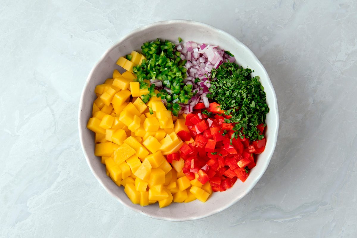 mango, red pepper, red onion, jalapeños, cilantro, salt and lime juice combined in a bowl
