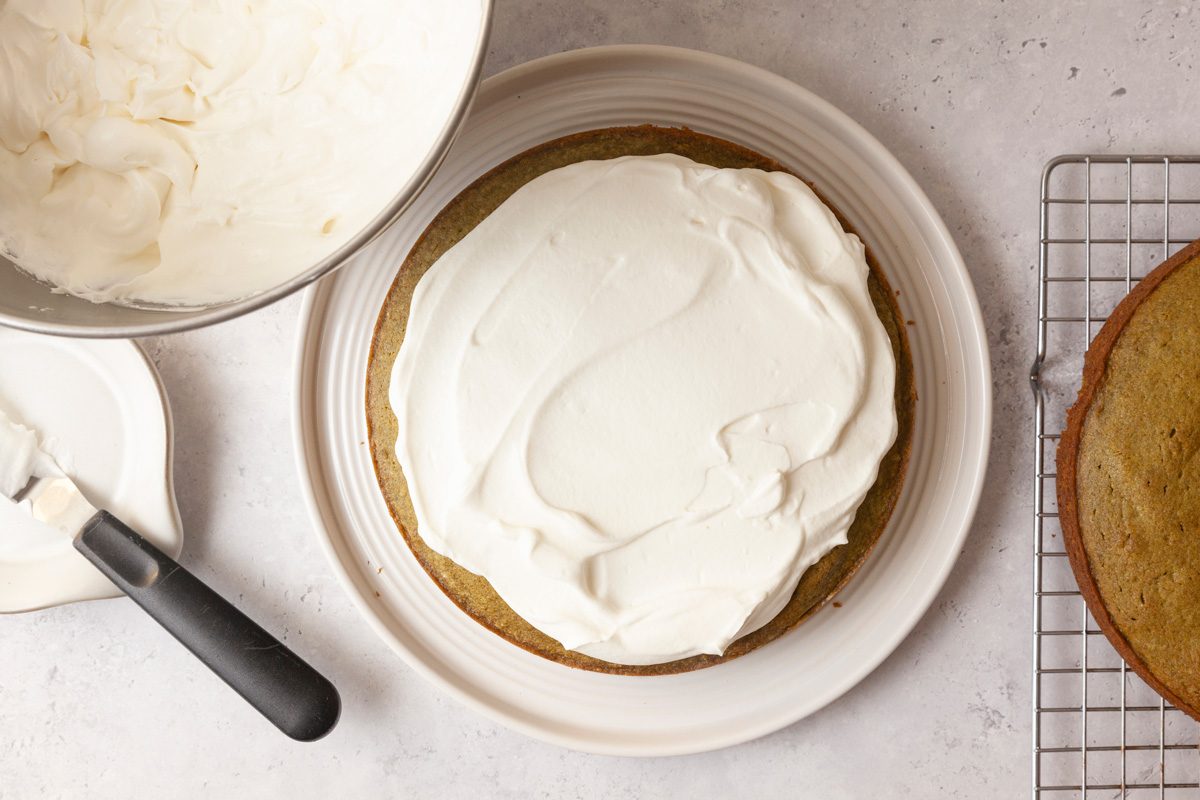 Overhead shot of whipped cream spread on top of the Matcha Cake