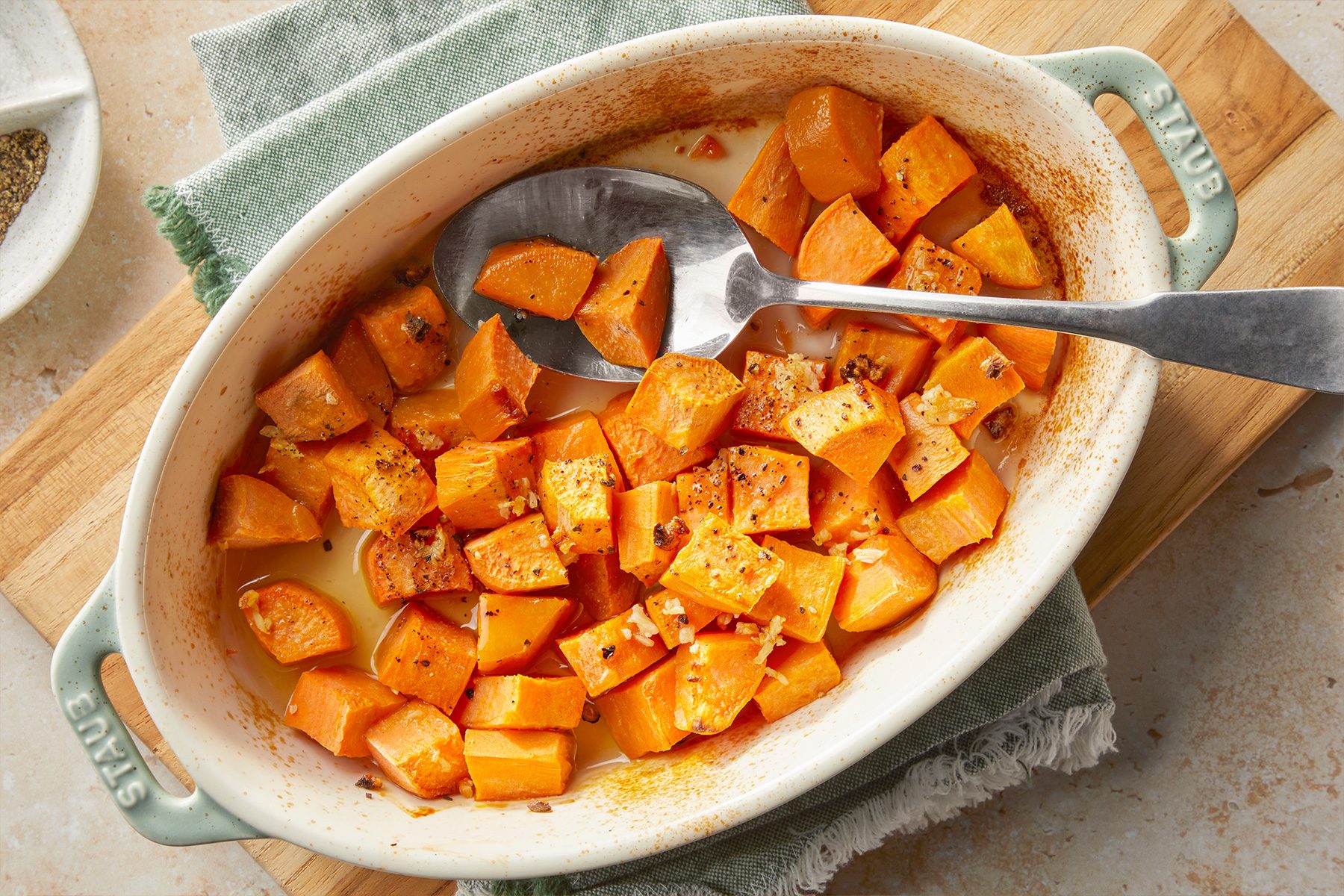 Roasted Sweet Potatoes in a bowl with sprinkled salt and garlic